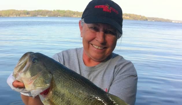 Woman holding a 7 pound bass fish