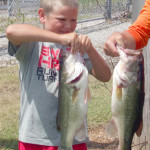 Castin Smith, 10 and Under age division, shows two of his bass for the day. SYBM photo