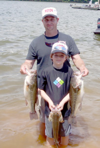 Hayden Smith with his dad Jason holding bass they boated. SYBM photo